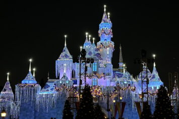 Disneyland castle with Christmastime lights at night